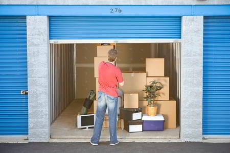 man closing storage unit