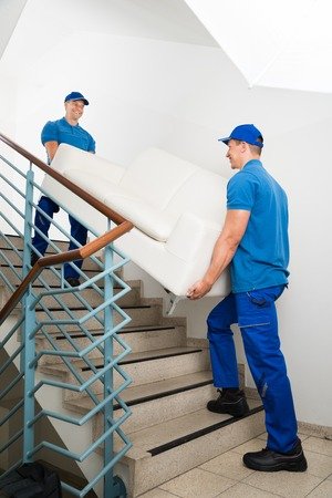 men lifting couch