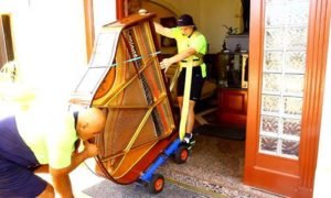 piano movers moving down stairs