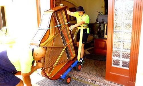 piano movers moving down stairs
